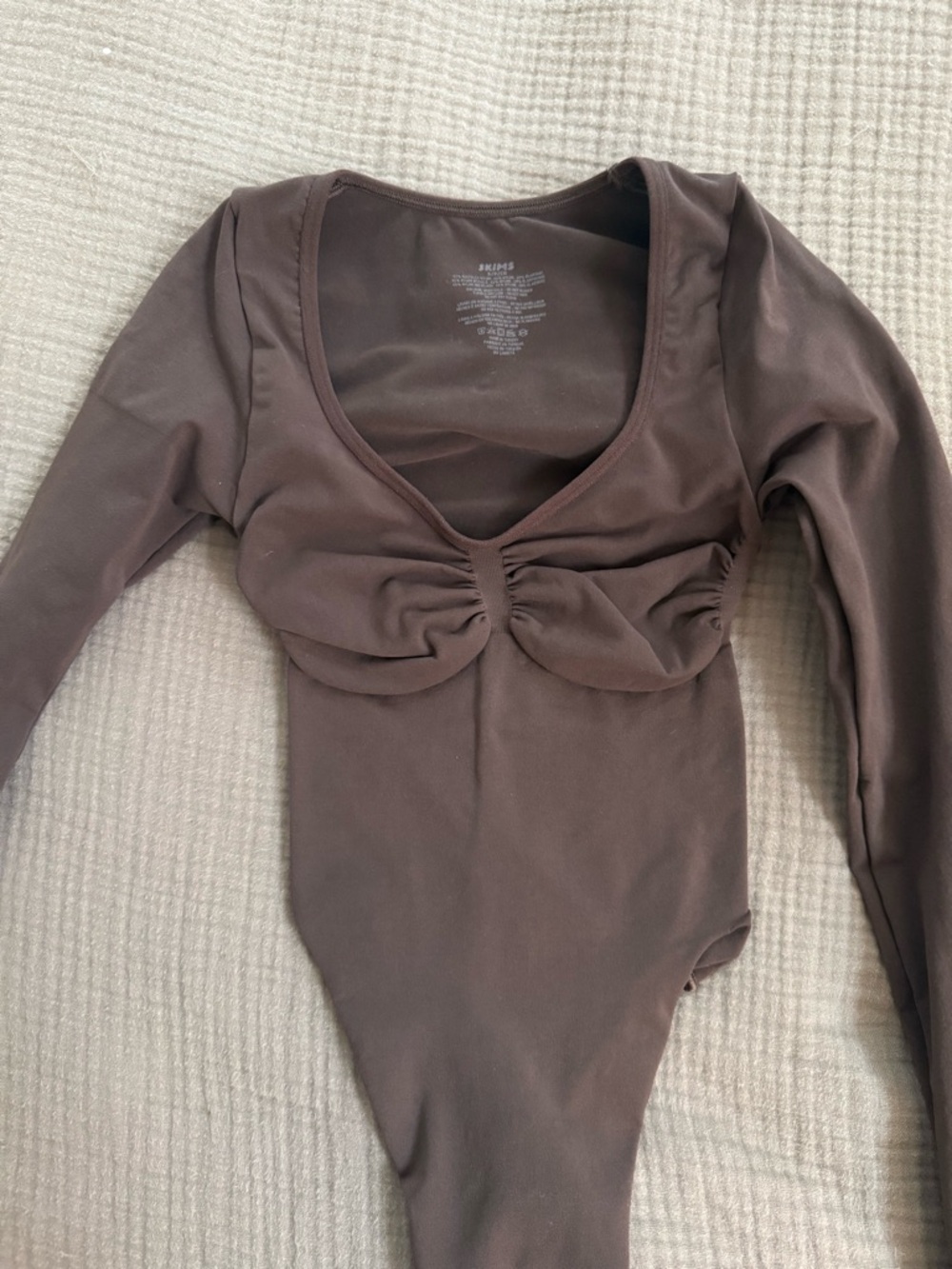 Skims Long Sleeve One-Piece Bodysuit in Dark Brown